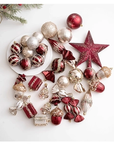 Champagne and wine red Christmas ornaments including stars, candy, and baubles on white