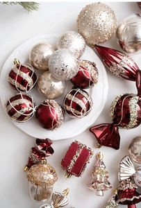Detailed view of champagne and red Christmas ornaments including balls and candy shapes