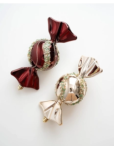 Close-up of candy-shaped Christmas tree ornaments in champagne gold and deep wine red