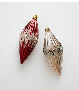 Detail of red and champagne finial Christmas ornaments with glitter and ribbed texture