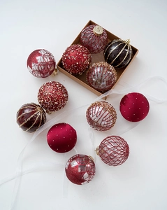 Detail showing champagne and wine red Christmas ornaments with beads and glitter details