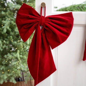 Large red velvet Christmas bow with hanging loop for festive holiday door or tree decoration