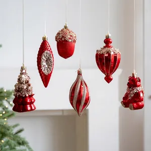 Red and gold Christmas tree ornaments set with bear and acorn shapes on festive background