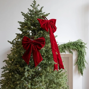 Large red velvet Christmas bows with long ribbons for festive tree and home decoration