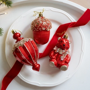 Christmas tree ornaments set with pearlescent red bear, acorn, and drop-shaped baubles
