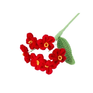 Handmade crochet forget-me-not flower with red petals and green stem on white background