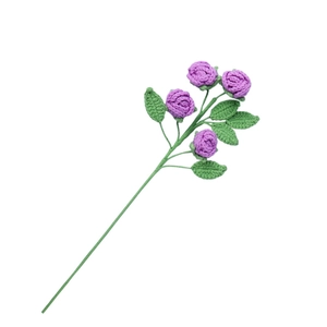 Handmade crochet purple roses bouquet with green leaves for gifts on a white background