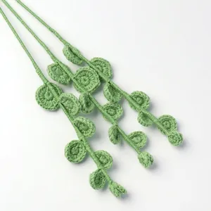 Handmade crochet eucalyptus hanging plant with green knitted leaves for home office decor
