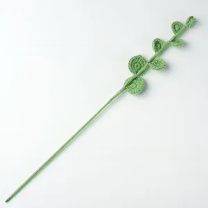 Close-up of handmade crochet eucalyptus leaves with detailed green knit textures