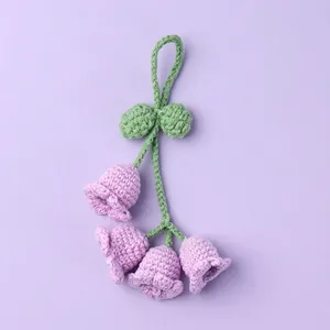 Handmade crochet lily of the valley keychain pendant in purple and green yarn