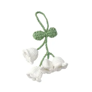 Handmade crochet lily of the valley keychain with white flowers and green leaves