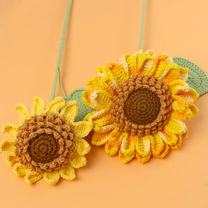Close-up of handmade crochet sunflower with detailed yellow petals and brown spiral center