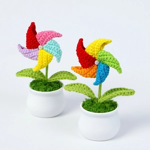 Macro detail of colorful crochet windmill flower pots with knit textures and pearl accents
