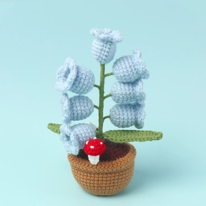 Detailed close-up of handmade crochet lily of the valley lamp with light blue flowers