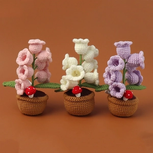 Detail of handmade crochet lily of the valley potted plants in pink white and purple