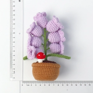 Detailed view of handmade purple crochet lily of the valley night light with scale