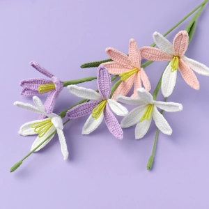 Macro shot of colorful handmade crochet flowers with detailed knitted lily petals