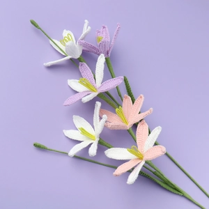 Detail showing handcrafted crochet flowers in white, pink, and purple yarn colors