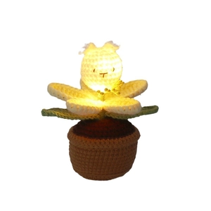 Handmade crochet bunny flower pot night light with LED glow on white background