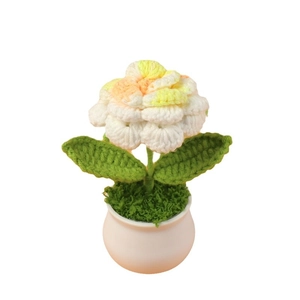 Handmade crochet rose flower potted plant with orange gradient petals and white ceramic pot