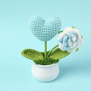 Detailed crochet blue rose and heart mini potted plant with green leaves in a white pot
