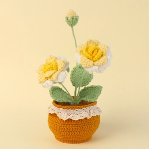Handmade crochet rose flower bonsai with yellow blooms and green leaves in a brown pot