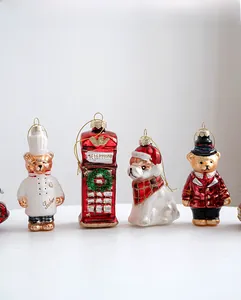 Detailed view of hand-painted Christmas glass ornaments with teddy bears and dog designs