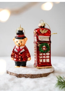 Detailed Christmas glass ornaments featuring a red guard bear and classic telephone booth