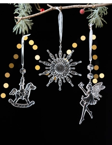 Detail of transparent Christmas tree ornaments with rocking horse and snowflake designs