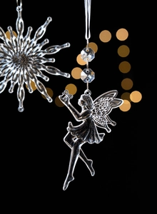 Exquisite transparent angel and snowflake hanging ornaments with festive bokeh background