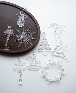 Clear acrylic Christmas tree ornaments including snowflakes, reindeer, and angel figurines