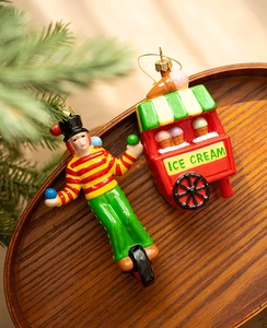 Detail of circus acrobat on unicycle and retro ice cream truck Christmas tree ornaments