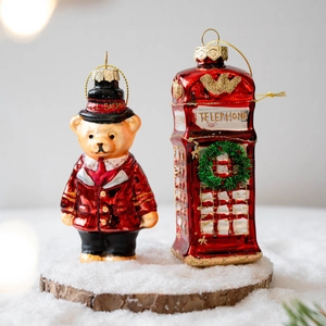 Christmas glass ornaments featuring a hand-painted teddy bear and red telephone booth