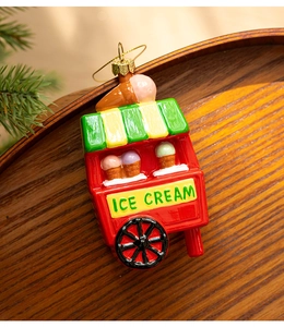 Close-up of red ice cream cart Christmas tree ornament with golden hanging string