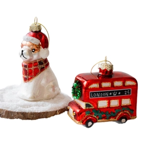 Christmas glass ornaments featuring a white bulldog and a red London bus with glitter