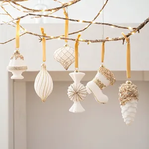 6-piece set of white and gold Christmas ornaments including mini cake and pine cone shapes
