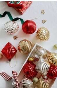 Detail of red and gold Christmas glass ornaments with glitter and embossed textures