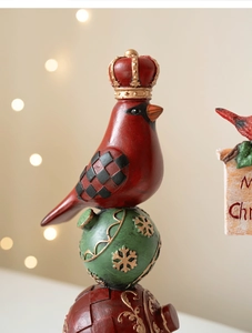 Macro detail of Christmas resin cardinal on festive ornament with Merry Christmas sign