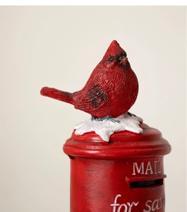 Close-up of red resin Christmas bird perched on snow-capped mailbox with Mail for Santa text