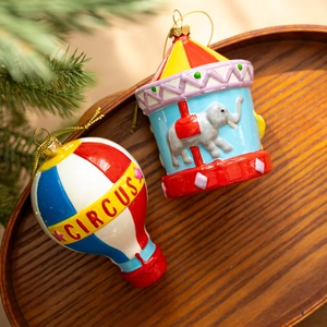 Circus themed Christmas tree ornaments featuring hot air balloon and carousel figures