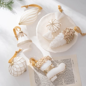 Elegant white and gold flocked Christmas ornaments set with velvet hanging strings