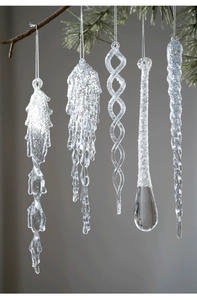 Detailed view of 5-piece set glittery clear acrylic icicle ornaments on pine branch