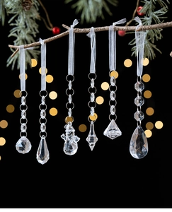 Set of six clear acrylic Christmas ornaments with faceted snowflake and droplet designs