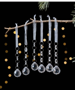 Detailed view of six hanging acrylic crystal balls with white ribbons for Christmas trees