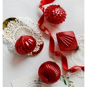 Luxurious red glass Christmas ornaments set with unique textures and golden hanging strings