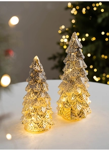 Détail de deux sapins de Noël en verre mercure avec lueur LED chaude et texture écaillée