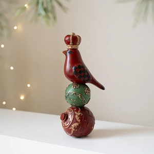 Christmas resin bird statue with golden crown and decorative festive ornament balls