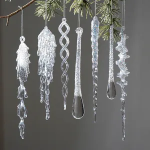 Transparent acrylic glitter icicle ornaments hanging on pine branches for Christmas tree