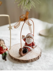Close-up of vintage resin Santa Claus on a wooden sled for Christmas tree decoration