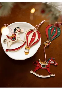 Close-up of vintage metal rocking horse and hot air balloon Christmas tree ornaments